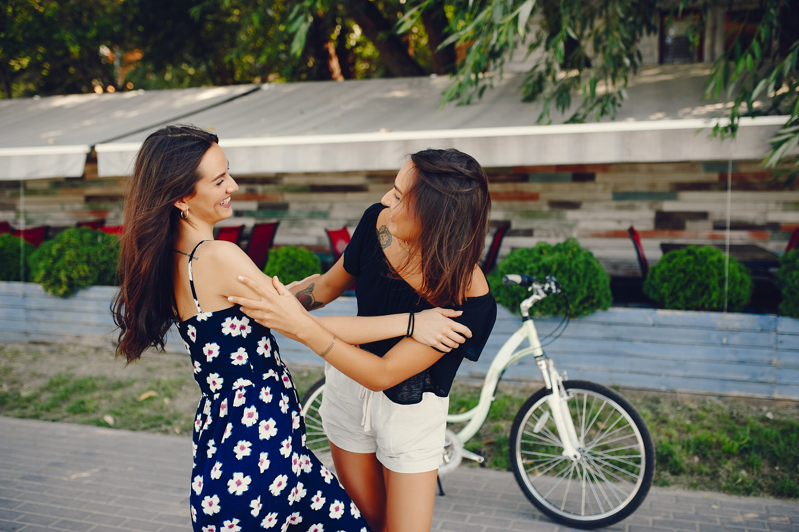 Beautiful girls in a park. Stylish girl with a bicycle.