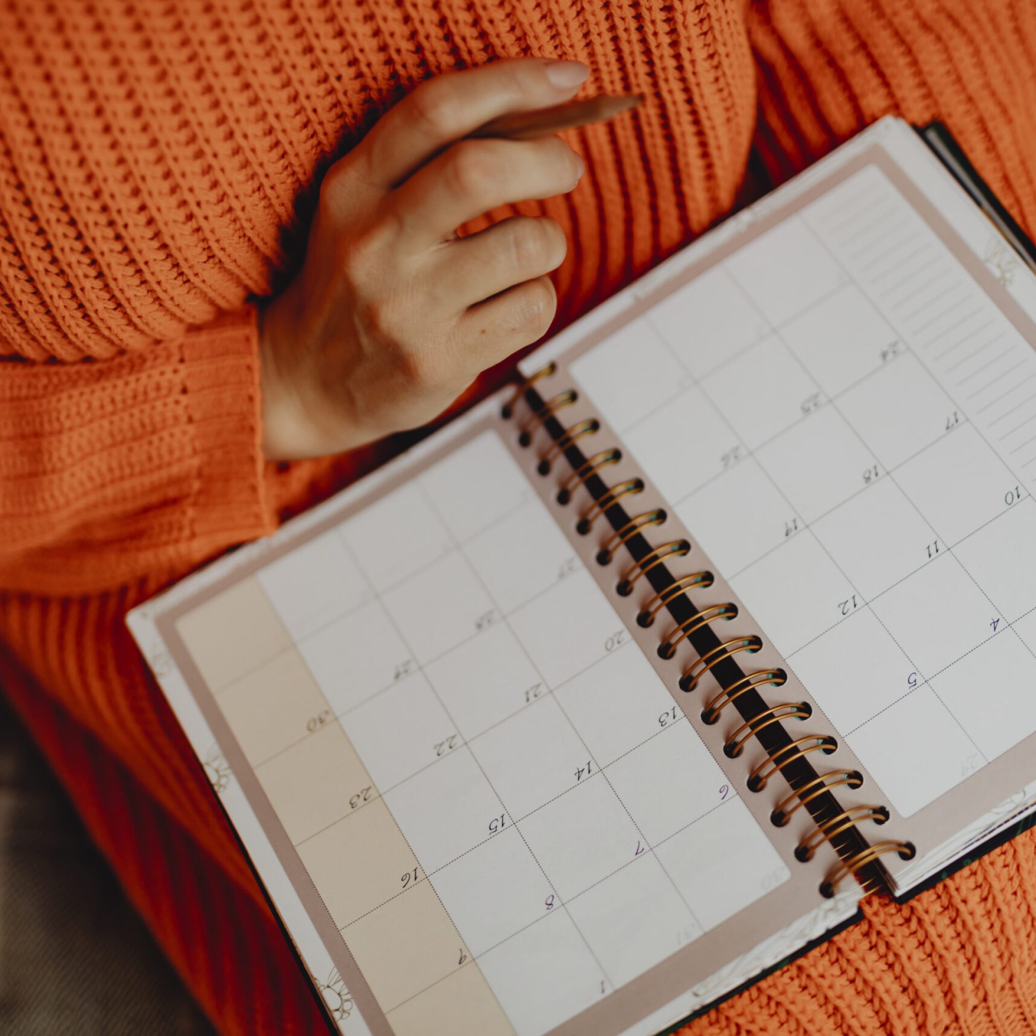 Woman writing on her daily planner